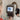 Optometrist using machine for eye exam with patient