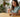 Woman adding collagen powder to coffee in kitchen